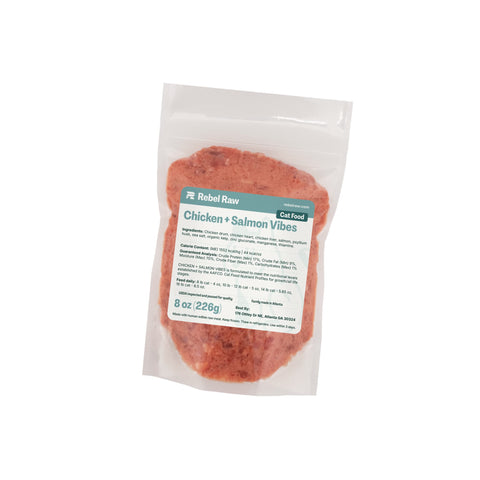 Package of Rebel Raw Chicken + Salmon cat food on a white background