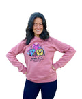 Woman posing with arms on hips in mauve Rebel Raw sweater.
